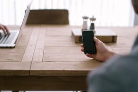 phone in the hands of a young man