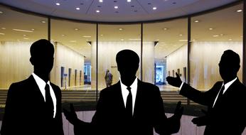 silhouettes of three businessmen at office, collage