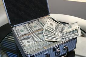 many dollars in a blue suitcase