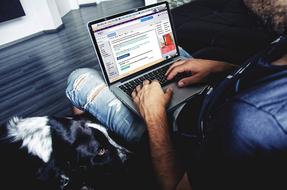 sitting man with laptop in the room