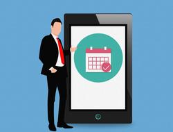 Man in suit, near the black tablet with colorful, round calendar icon, on clipart