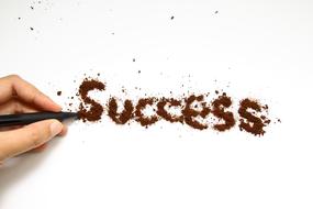 inscription success, hand, pencil and ground coffee
