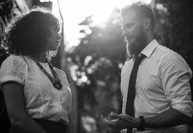 black and white photo of colleagues talking in the park