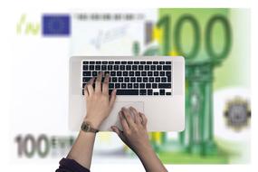 male Hands on Keyboard at euro bank note background