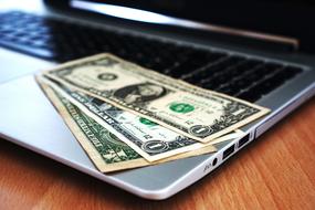 dollars are on the laptop