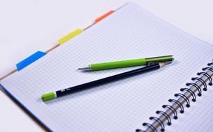 notebook with pen and pencil