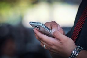 silver smartphone in woman's hands