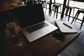 laptop and coffee on the table in the cafe