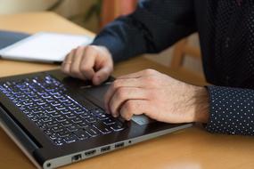 male Hands at Work on keyboard of Computer