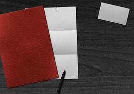 blank red and white sheets of Paper and Business Card on desk