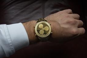 Cryptocurrency watch on the man's hand