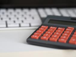 Calculator with red keys on desk