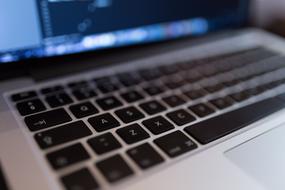 Coding, keyboard of laptop close up