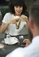 Couple, drink coffee and using smartphone, in the cafe