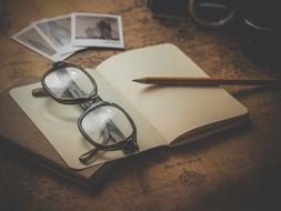 Old Retro glasses and photo and pen