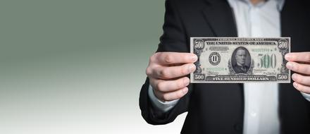 dollar bill in hand