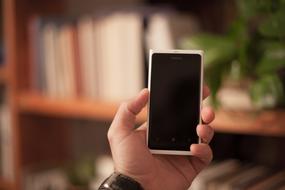 smartphone with black display in men's hand