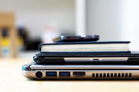 stack of gadgets on desk in office