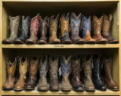 two shelves with cowboy boots