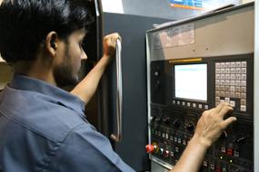 the man stands near the control panel