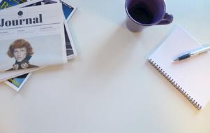 Newspaper and pen and notebook