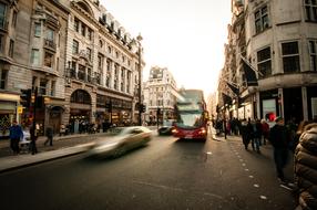 Beautiful landscape with the people and cars in motion, on the beautiful streets in light