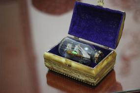 Beautiful box, with the bottle, with the ship, on the wooden table, with the reflections