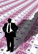 businessman stands on euro bills, drawing