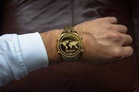 Cryptocurrency symbol on clock face of wrist watches on male hand