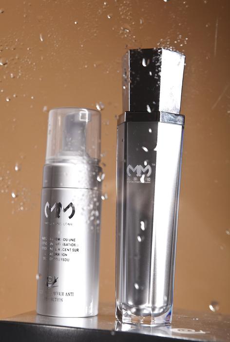 two bottles with Cosmetic products and Water Drops