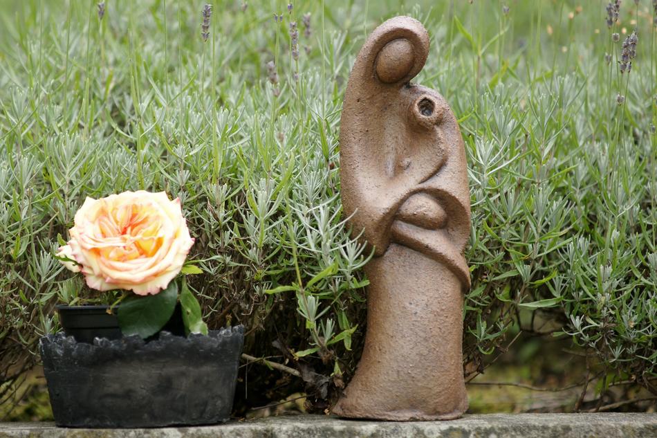 Rose and Sculpture of Woman With Child