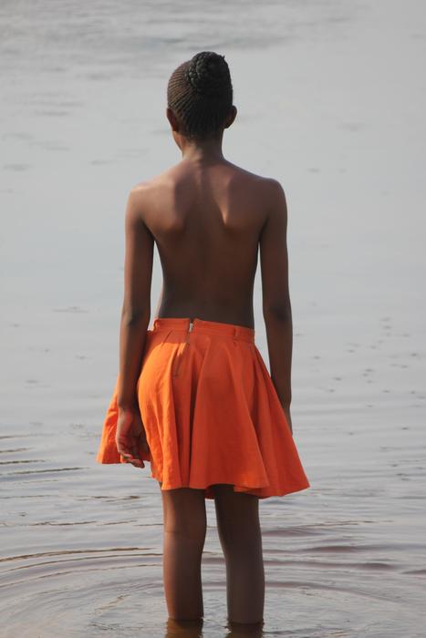 Girl dressed up in Orange skirt