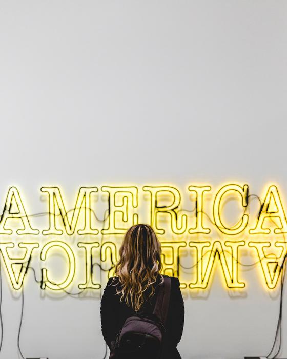 girl looking at a sign that's lit up
