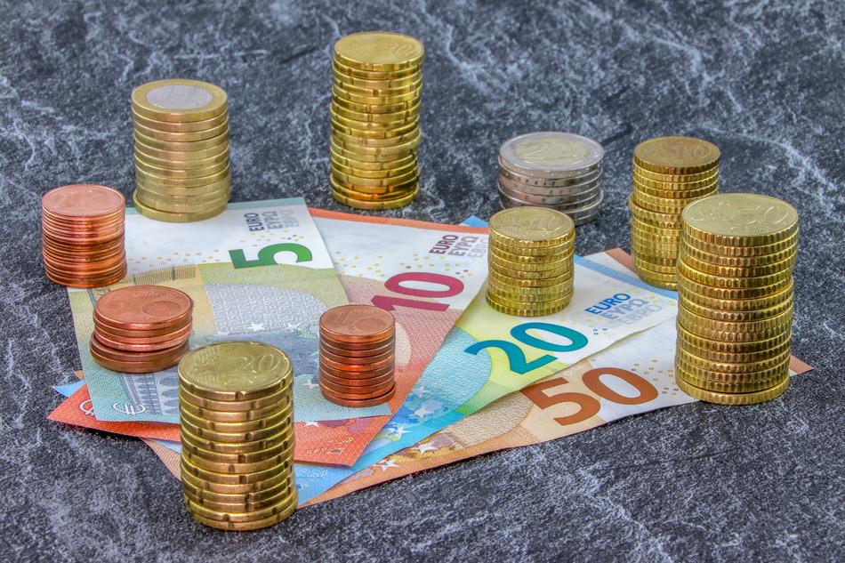 tower of coins on banknotes