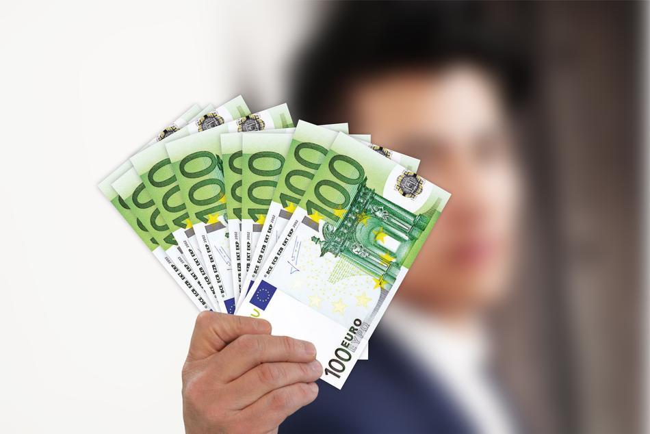 euro bills in hand of caucasian man