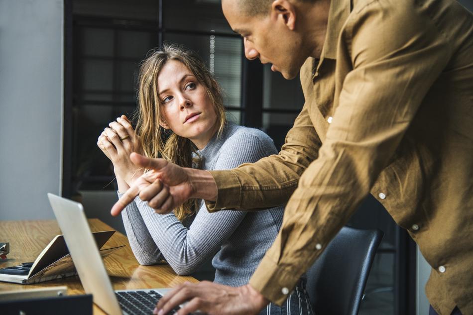 man and woman at the table in the office