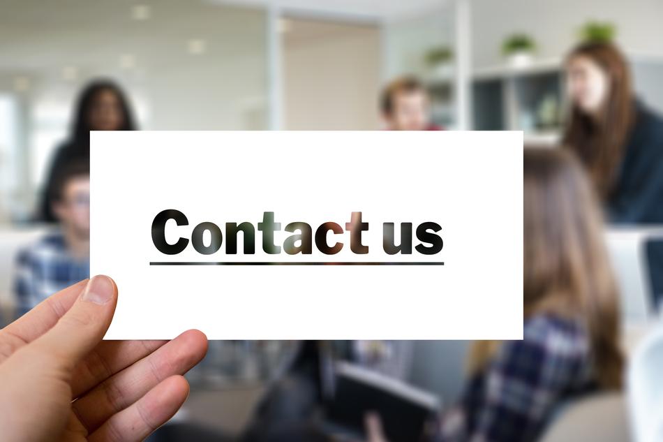 Contact us against the background of a blurry office