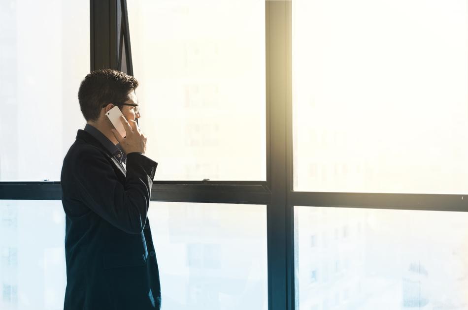 man with phone near the window