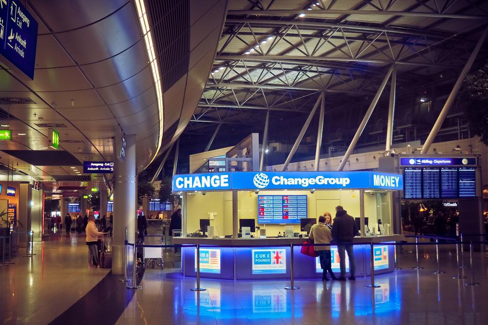 People in the airport with colorful lights in DÃ¼sseldorf, Germany