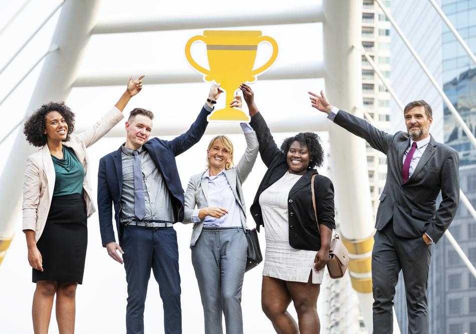 yellow cup in hands as a symbol of success