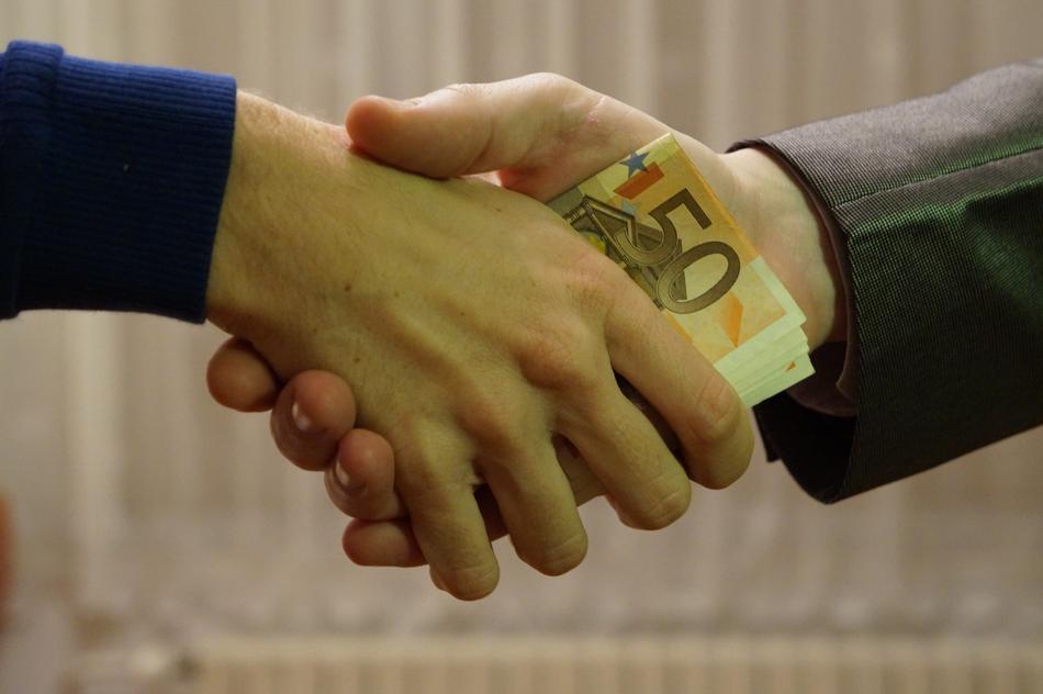 Euro banknotes transfer through handshake
