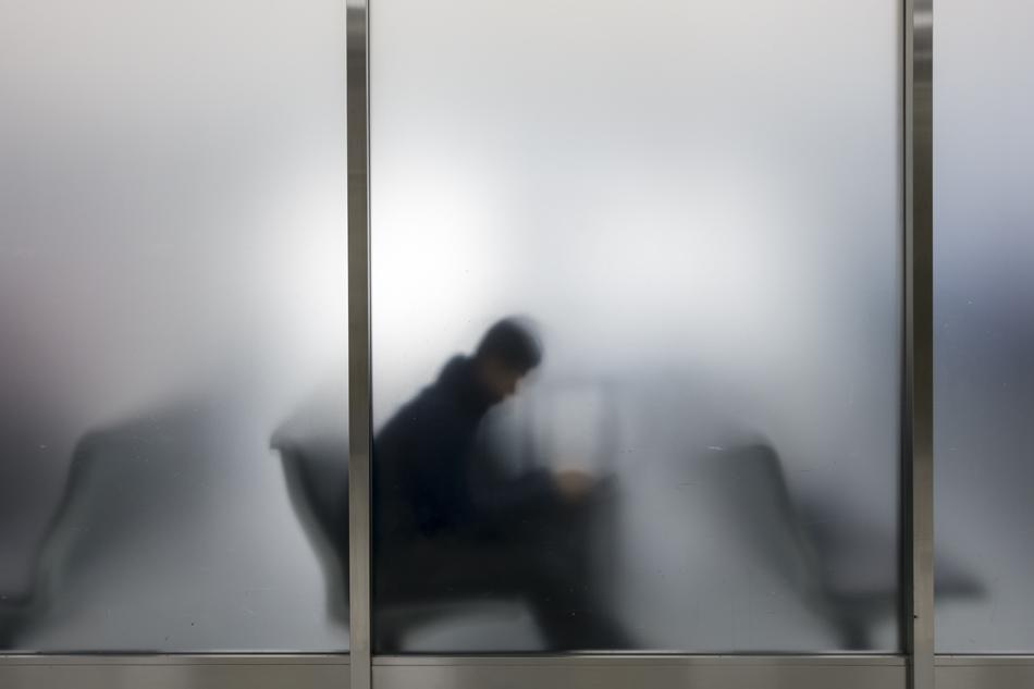 silhouette of a man at the airport behind the wall