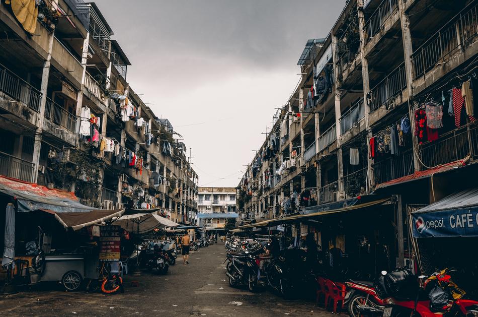 Street view with the markets and colorful clothes hanging on the balconies under cloudy sky