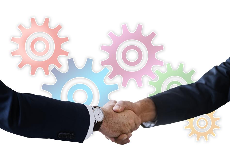 Handshake against the background of colorful gears