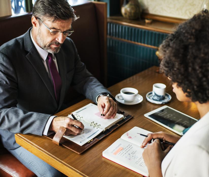 businessman and woman at table