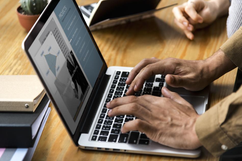people with laptop at desk