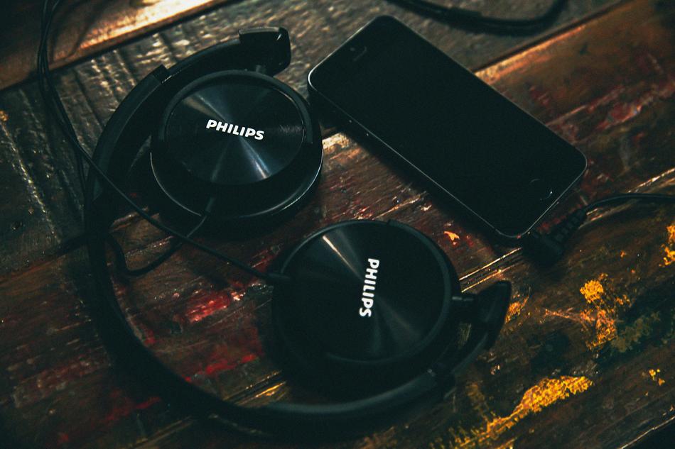 black Headphones and smartphone on desk