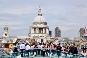 Crowd on the Millennium bridge near the beautiful St Paul's Cathedral in London, England, UK