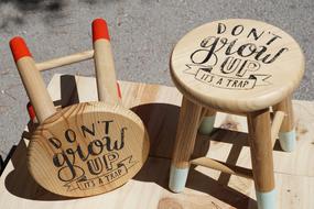 donât grow up, itâs a trap, writing on wooden stools