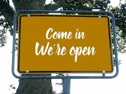 come in we are open, shield on pole beneath tree